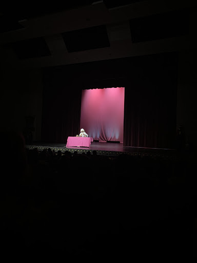 Senior Logan Edwards displays his humor during the talent portion of the competition, putting on a wig and makeup with the help of Ryley Brekkas (12). 