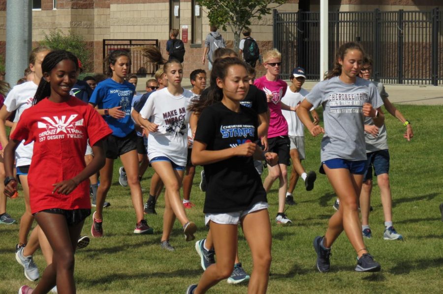 Leading the pack. Soonhee Han (12) leads the Cross Country team through a warm up during practice on August 26, 2019. Han explained that an important part of being a leader is “...setting a good example and doing what’s right because the freshman...look up a lot to see what to do…” Han, like many other leaders in the school, aims to add to the community through helping others within their sport or club.