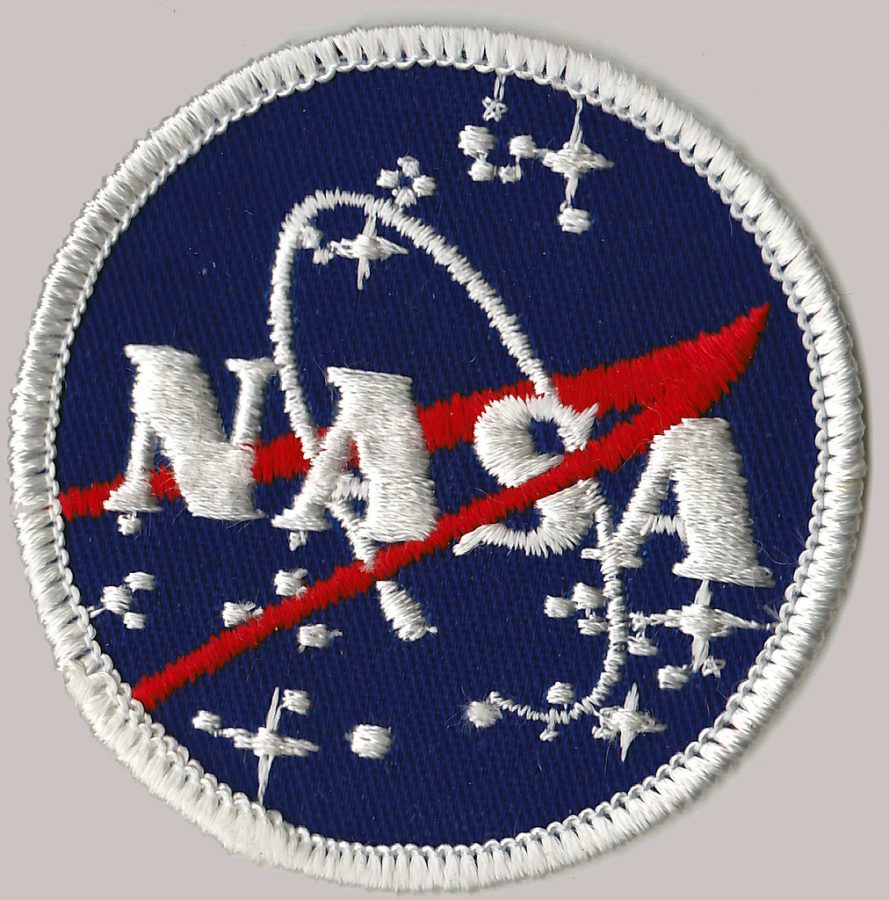 The+NASA+badge+glints%2C+illuminating+the+bold+red+and+blue+threads+of+the+nation%E2%80%99s+premiere+space+exploration+agency%E2%80%99s+emblem.+The+patriotic+colors+of+the+logo+are+emphasized+after+the+first+all+female+space+walk.