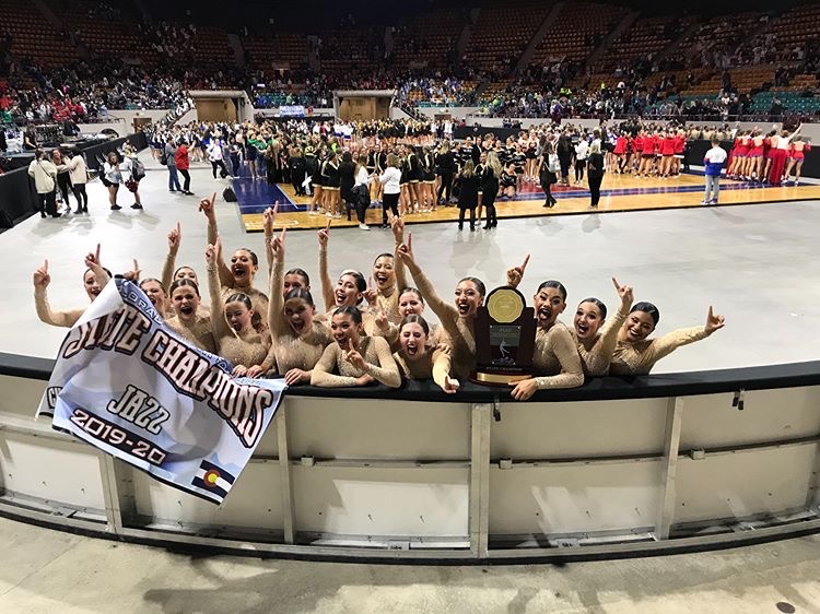 Victory! The poms team celebrates their first state title in jazz. ““Everyone was cheering us on,”  Emarie Rodriguez (12) expressed. Their groundbreaking choreography shocked not just everyone in the audience but the other competitors as well. 